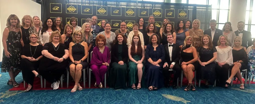 CLIA Hall of Fame Inductee Mandy Goddard, her family, and fellow KHM Travel Group Agents at Cruise360